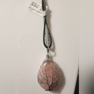 Wire-wrapped rose quartz teardrop pendant with a tree of life design.